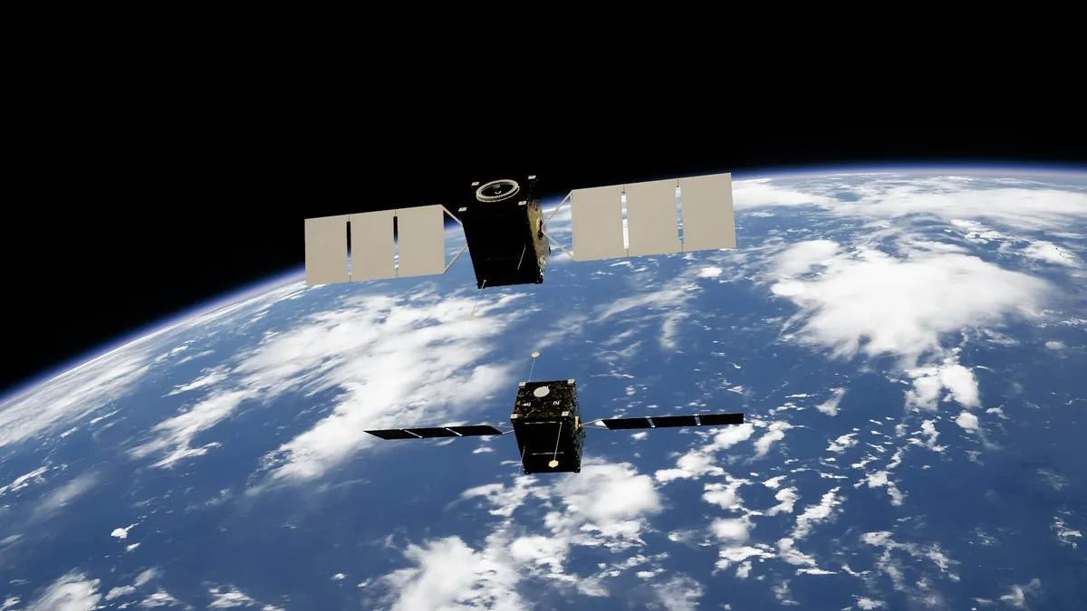 A satellite in space above the Earth, with the satellite's solar panels and antennae visible.